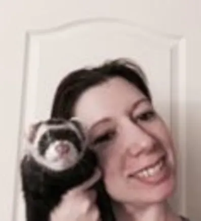 Barbara Krecko's staff photo from Shinnecock Animal Hospital where she is holding a black and white ferret.